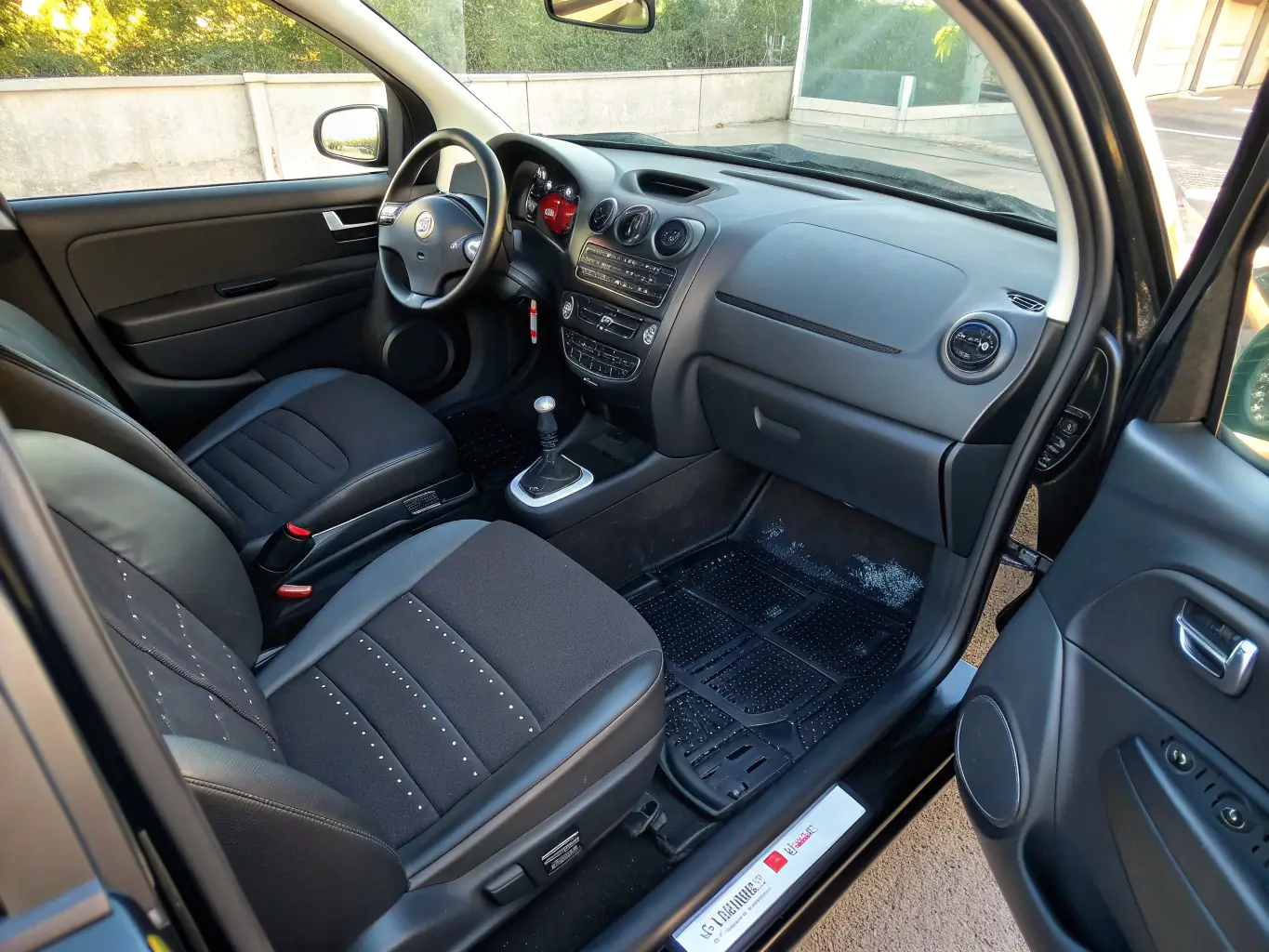 A wide shot of a car interior fully equipped with Rafallinescom accessories, including seat covers, floor mats, and a steering wheel cover, creating a cohesive and stylish look, highlighting the brand's minimalist design philosophy.